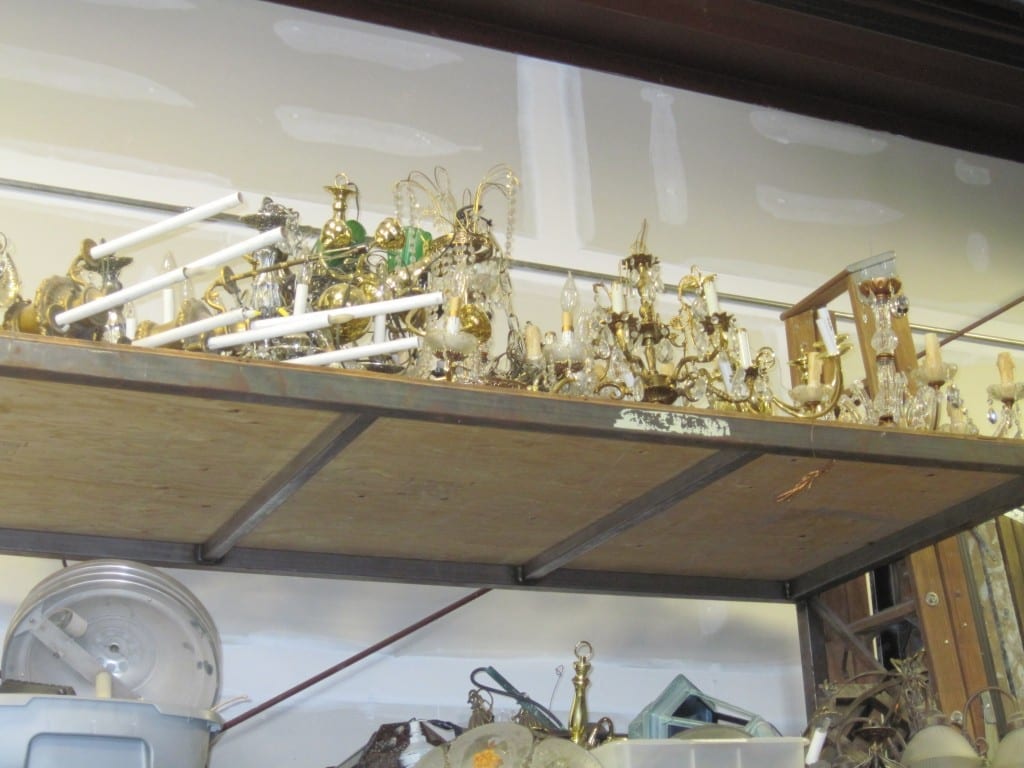 Dozens of candlesticks, candelabras, and chandeliers have their own shelf in the storage facility.