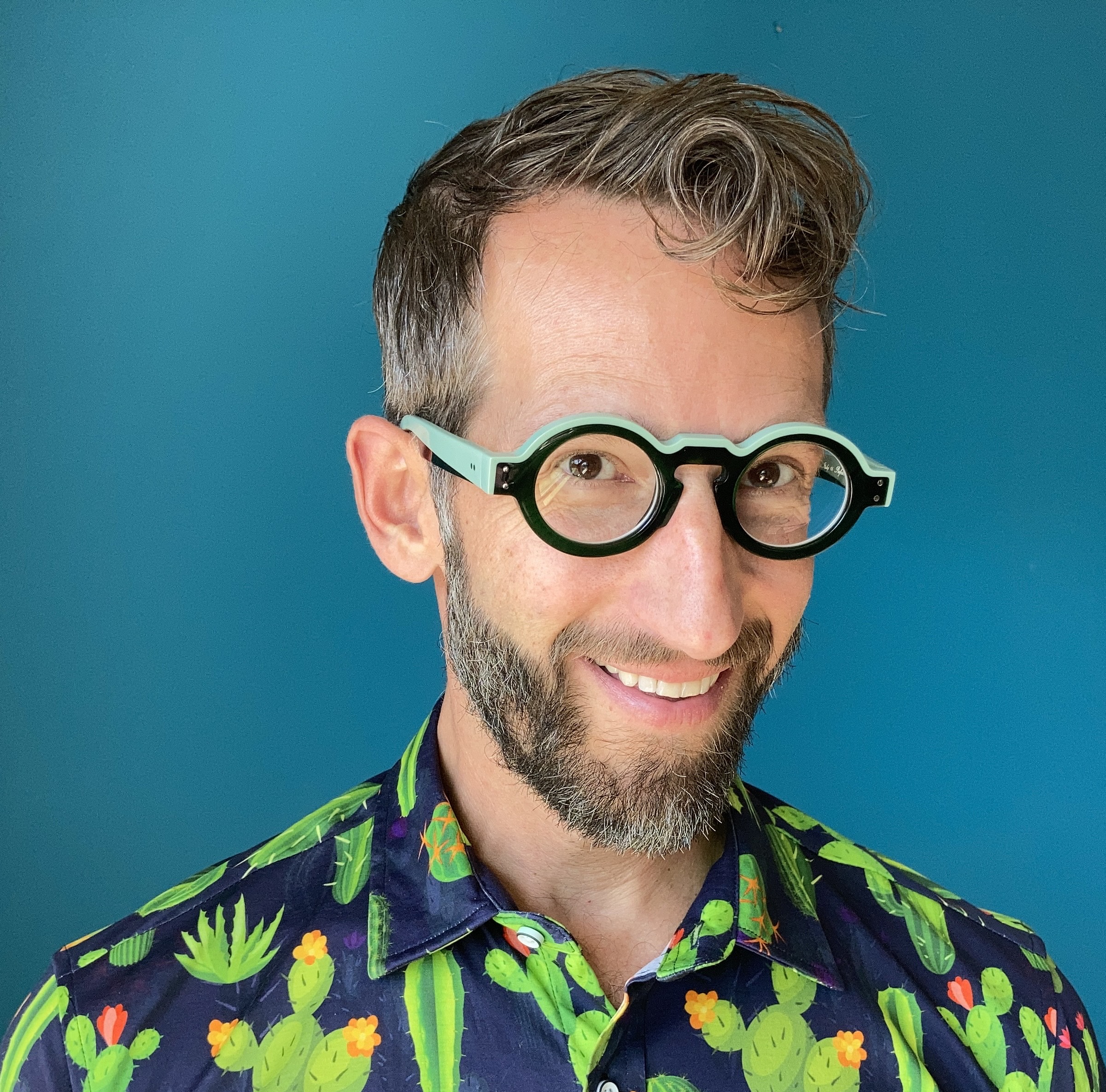 Actor Alexis Baigue, set against a blue background.